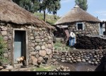 Traditional Basotho rondoval house made of stone with a thatch roof in Lesotho, Southern Africa
